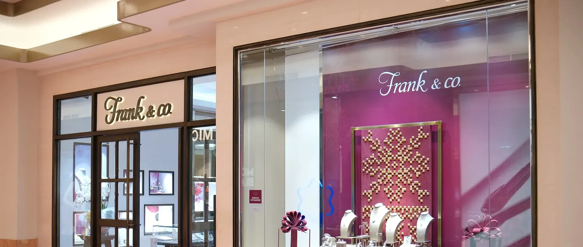 The finished Frank & Co Christmas window on display behind the store's glass front