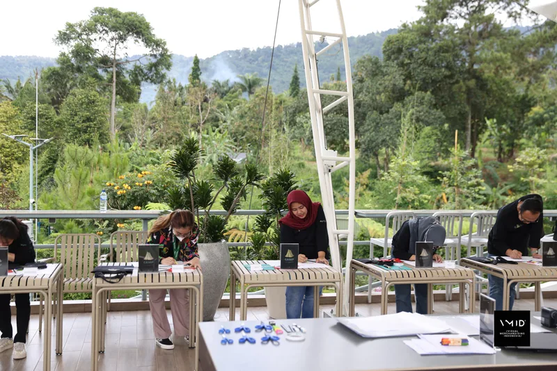 Participants drawing at a row of tables along the pavilion railing, trees and hills beyond — CAMP 2023