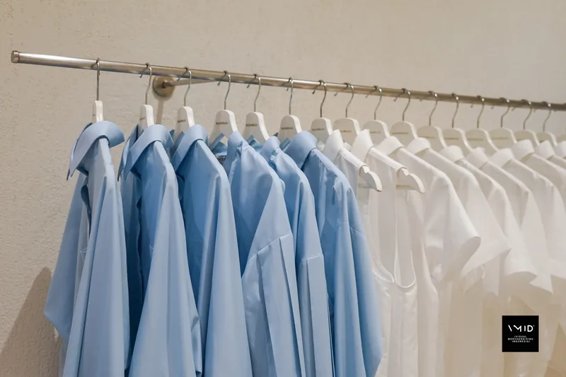 Pale blue shirts giving way to white along a wall rail — Masshiro&Co., 2022